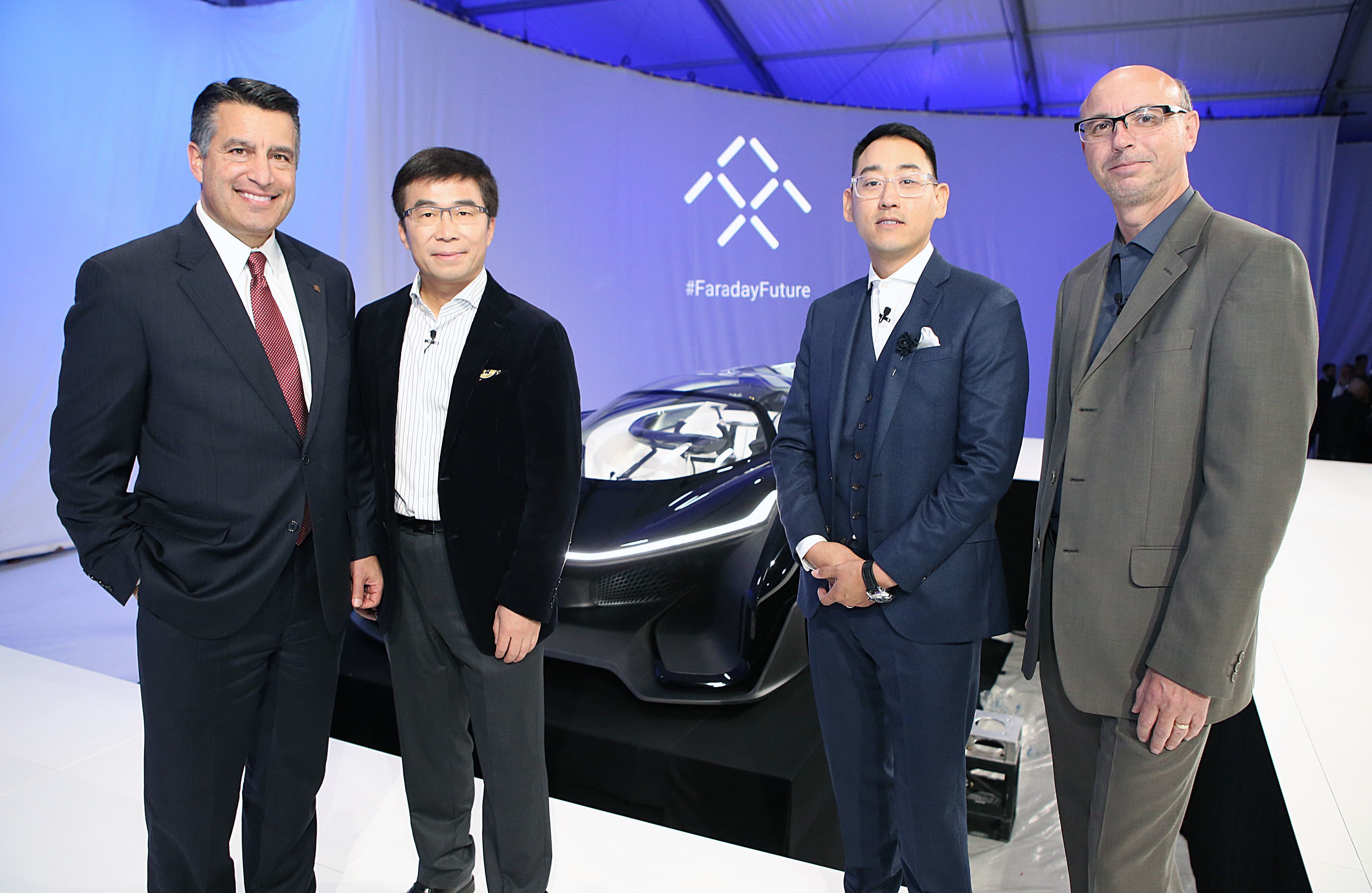 Governor Sandoval, left, Ding Lei, Co-Founder, Global Vice Chairman, Managing Director, SEE Plan, Letv, second left, Richard Kim, Faraday Future Global Design Director, second tight, and Nick Sampson, VP of R&D and Engineering pose for a photo during Faraday Future's pre-CES reveal of FFZERO1 Concept in Las Vegas on Monday, Jan. 4, 2016. (Bizuayehu Tesfaye/ AP Images for Faraday Future)