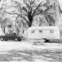 This photo, from the Airstream corporate archives, shows a family enjoying their vacation in style. The car appears to be a circa 1948 Studebaker, and it’s towing a large Airstream trailer of the same vintage. Judging by the Spanish moss hanging in the trees we’ll say this is somewhere south of the Mason Dixon line