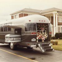 Here’s the exterior view of the Airstream Funeral Coach, circa 1982. It was a decent idea, having one vehicle that could take the place of several. The flowers went into the rear hatch area, as shown, while the casket went into the side carrier space. Mourners rode inside the spacious passenger compartment, which was nicely trimmed and featured individual seats plus a couch at the rear.