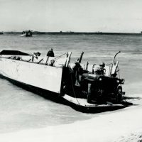 It took great courage to overcome one’s fears and drive off a landing craft under fire, but many a young man had to do it. Notice the snorkels mounted on the Jeeps; these are for fording deep water.