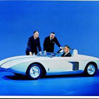 Ford teased sports car fans in 1962 with a two-seat Mustang prototype. The name became “Mustang I” in 1963 after the Mustang II show car was unveiled. Standing left to right are engineering vice president Herb Misch and design chief Gene Bordinat. Chassis engineer Roy Lunn is at the wheel. Photo: Ford Motor Company.