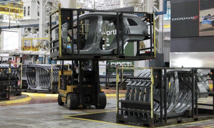 A forklift driver moves racks of Jeep Cherokee body side panels at the FCA US Sterling (Michigan) Stamping Plant. With nearly 3 million square feet of floor space, the 50-year-old plant is the largest stamping plant in the world and produces more than 62 million parts annually. Photo: FCA