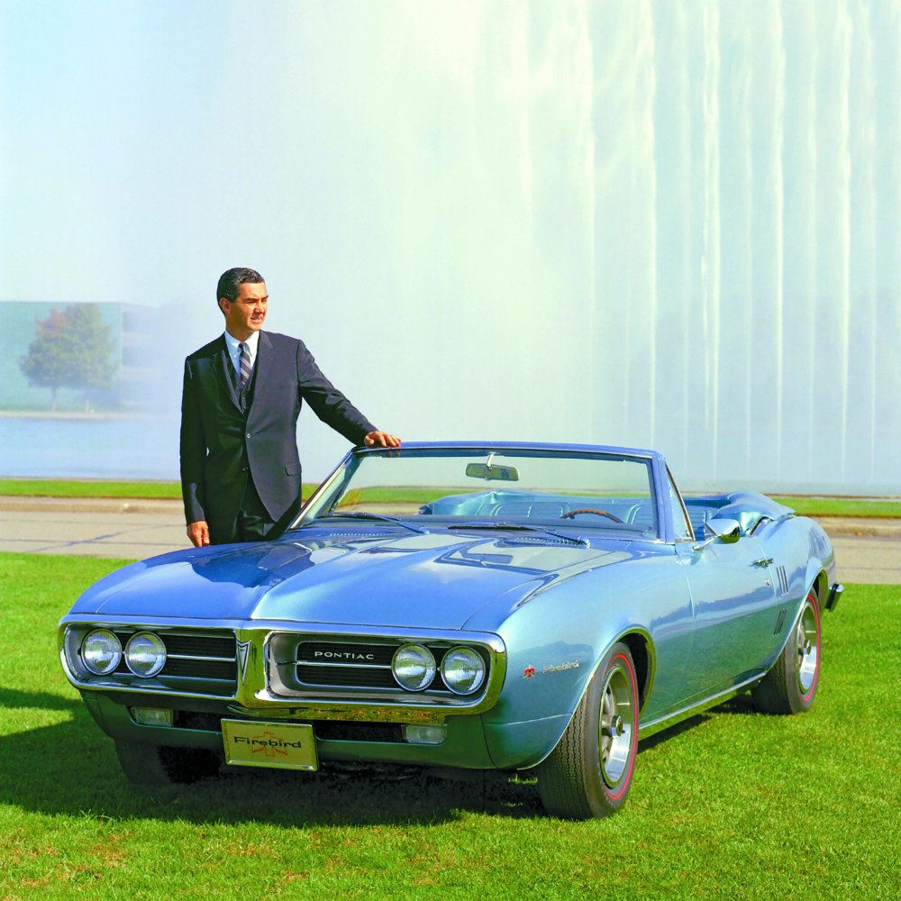 John Z. DeLorean poses beside a car he originally didn’t want to build - the Firebird.
