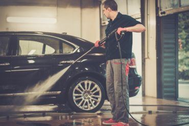 man worker washing luxury car on a car wash PE2NHXS
