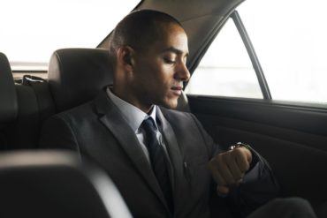 businessman sit inside car waiting PJLJEF9