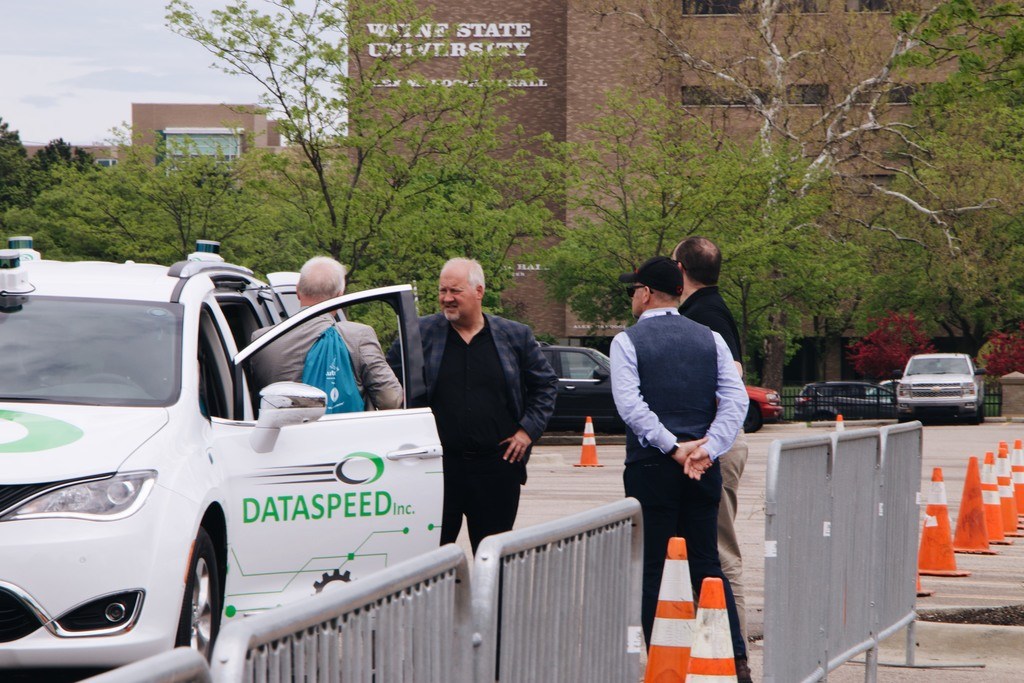Dataspeed Founder Paul Fleck (black shirt, jacket, middle) talks with AutoSens Detroit attendees in May 2018. Dataspeed showcased the company’s ADAS Kit which helps engineers maximize their development of autonomous systems in the field.