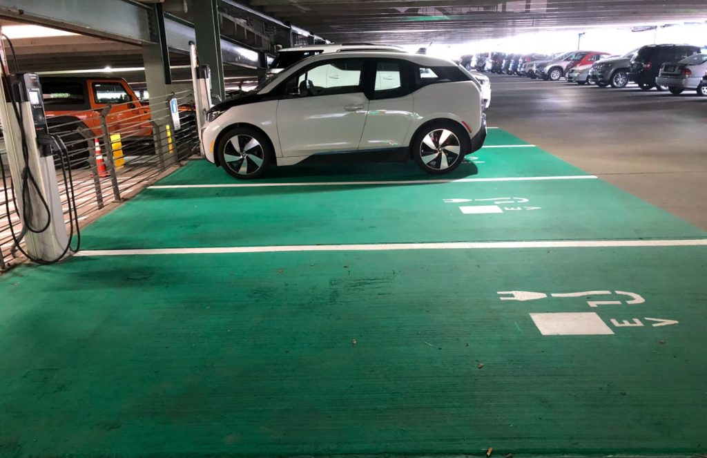 Electric vehicle charging in a parking garage. 