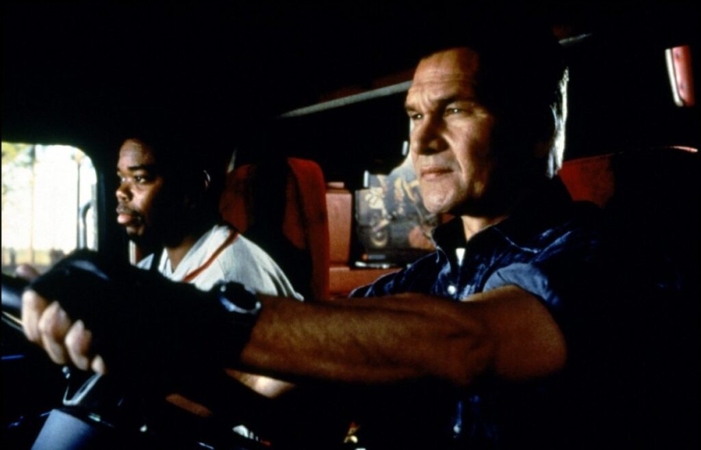 Sonny (Gabriel Casseus) and Jack Crews (Patrick Swayze) in Black Dog, distributed by Universal Pictures.