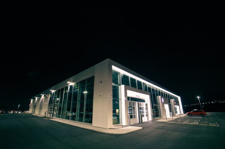 an empty car dealership parking lot at night