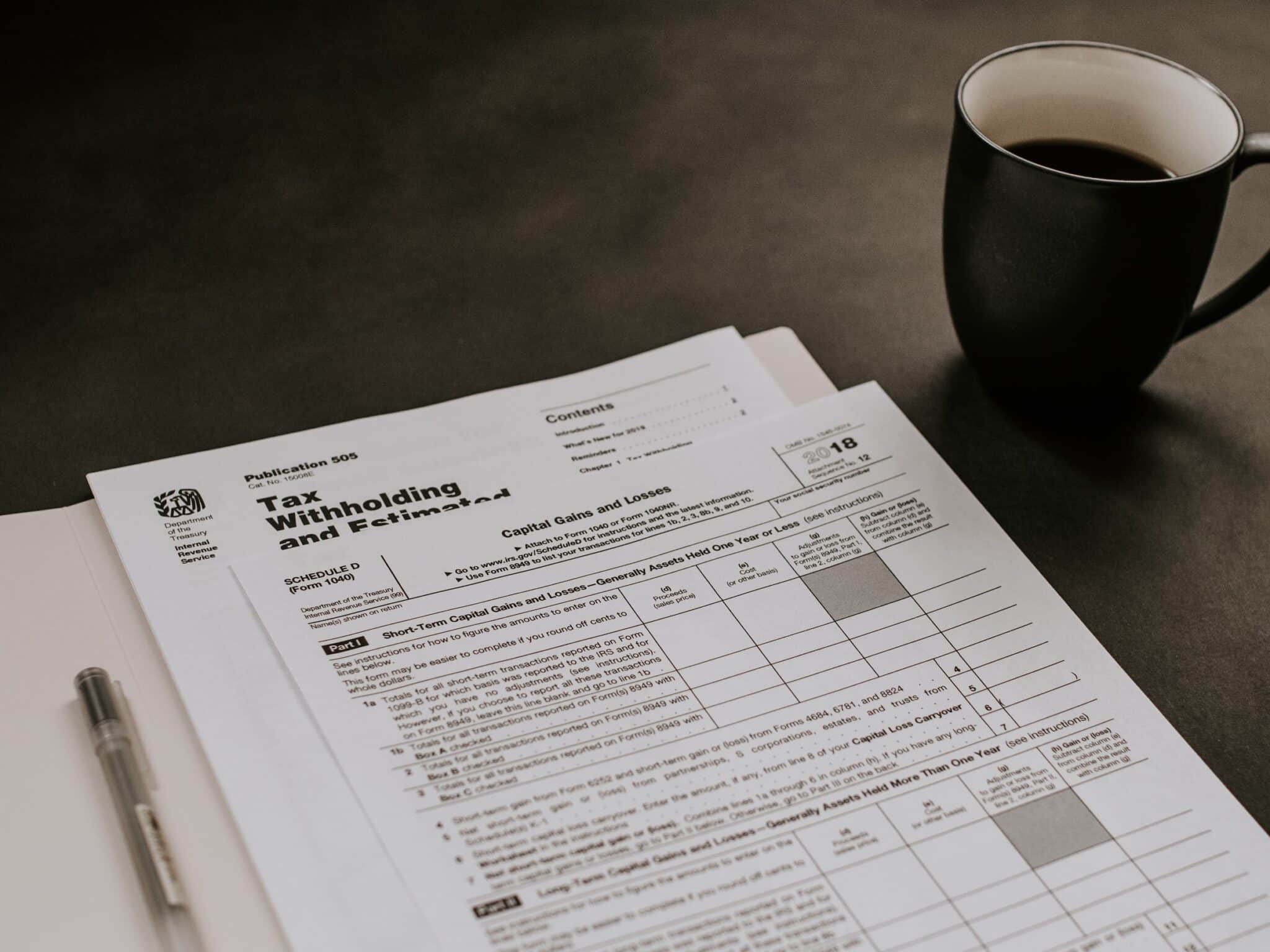 a tax form sitting next to a cup of coffee