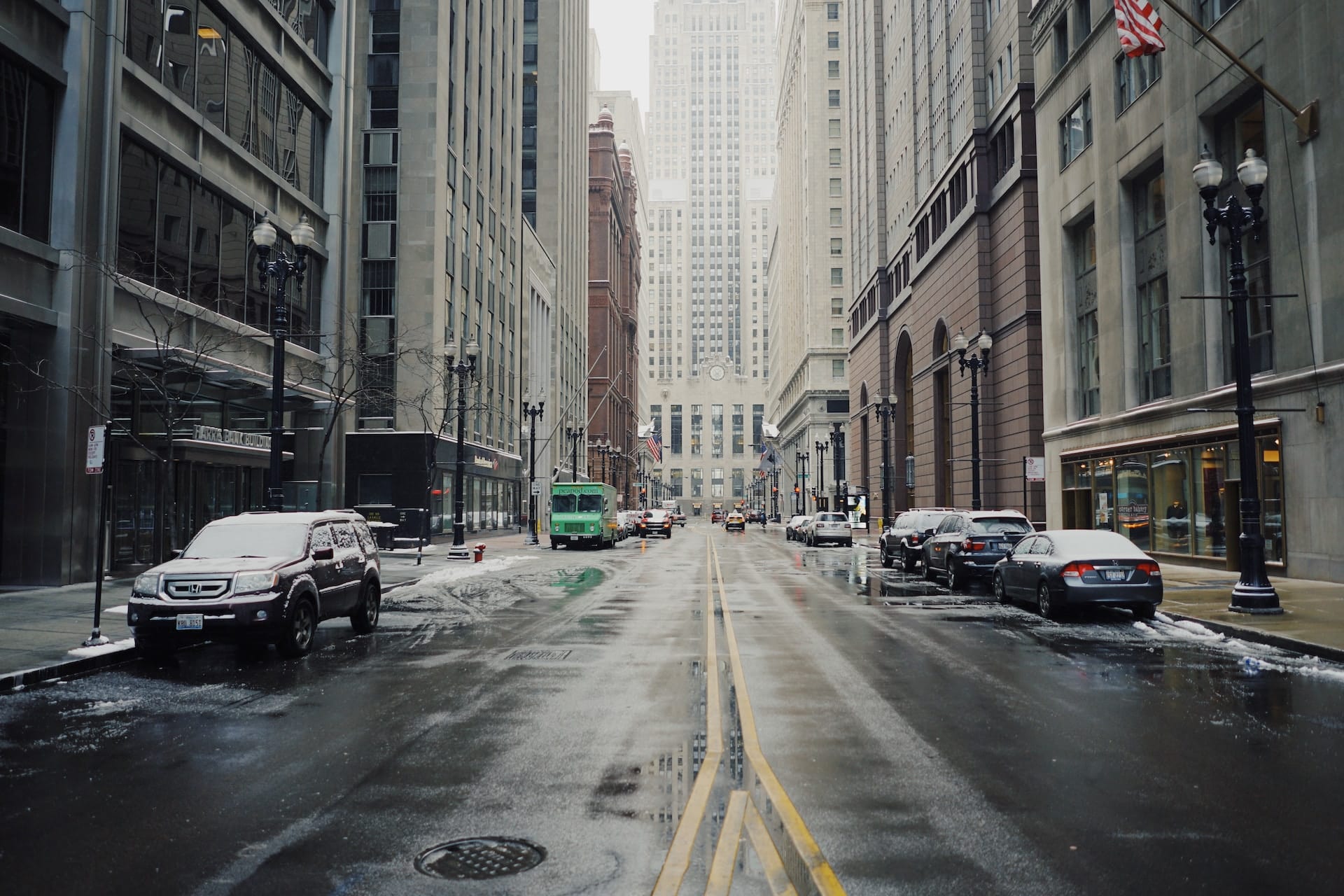 cars parked on chicago street in snow