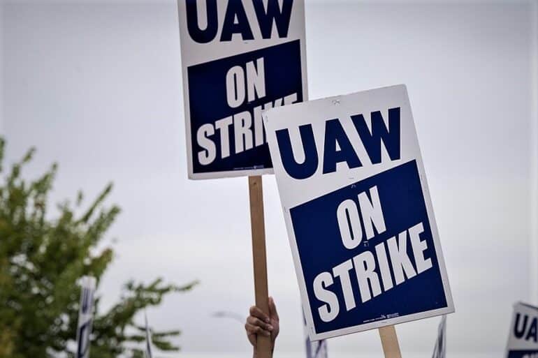 uaw strike signs held up in the air