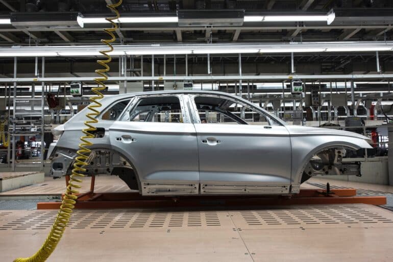 a car bring assembled in a standard auto industry factory